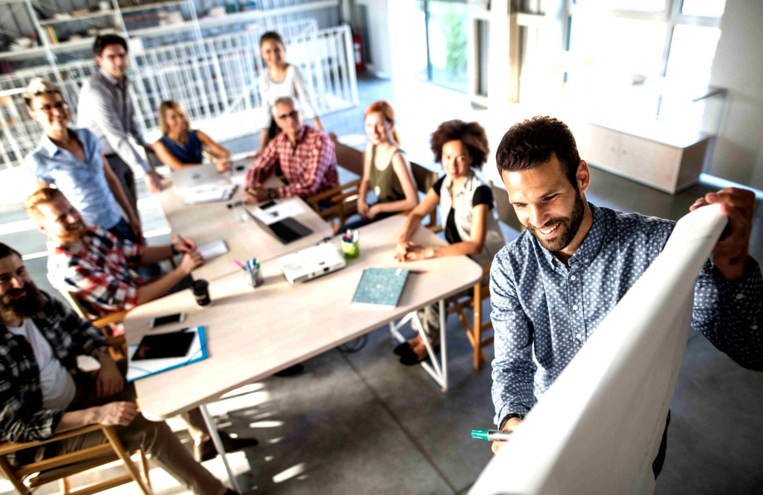 Consultant financier analysant des graphiques et des données sur plusieurs écrans dans un bureau moderne